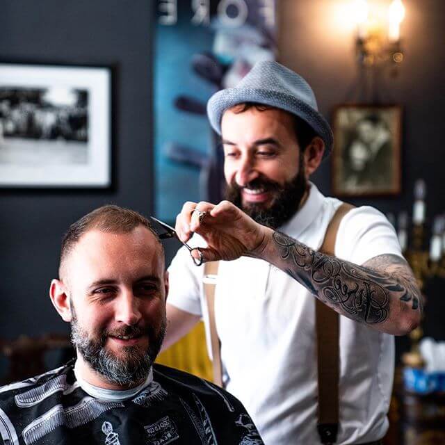 Barber cutting man's hair low skin fade